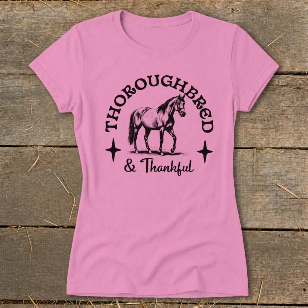 Pink t-shirt with black graphic of a thoroughbred horse and text "THOROUGHBRED & Thankful".