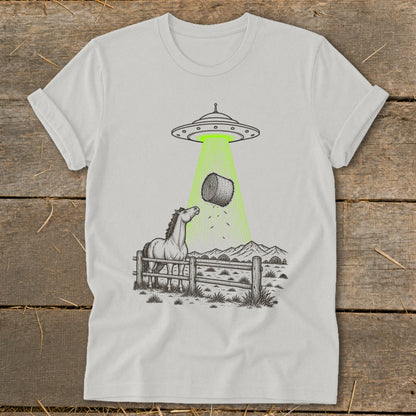 UFO beaming a hay bale from a horse in a fenced pasture.