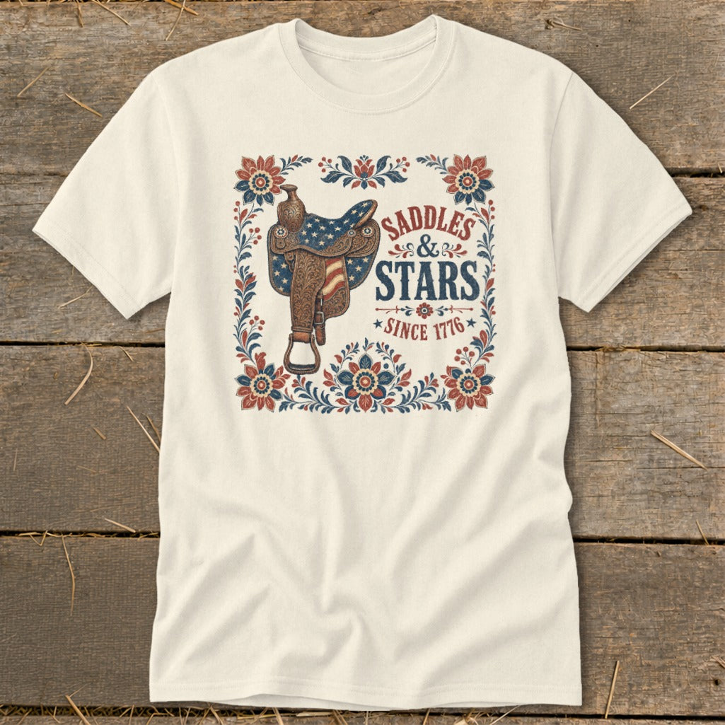 Cream t-shirt with a saddle and "Saddles & Stars Since 1776" text design.