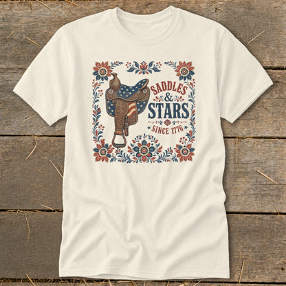 Cream t-shirt with a saddle and "Saddles & Stars Since 1776" text design.