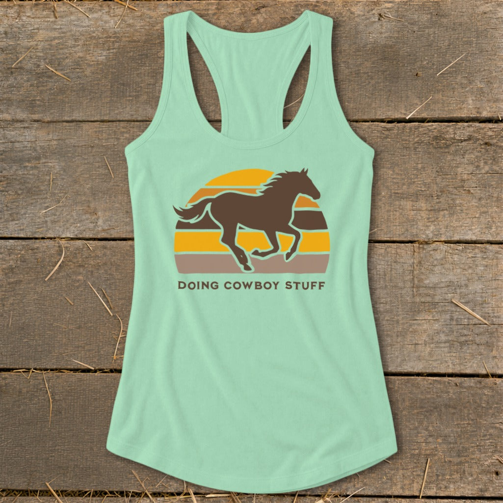 Mint green tank top with brown horse silhouette and "Doing Cowboy Stuff" text.