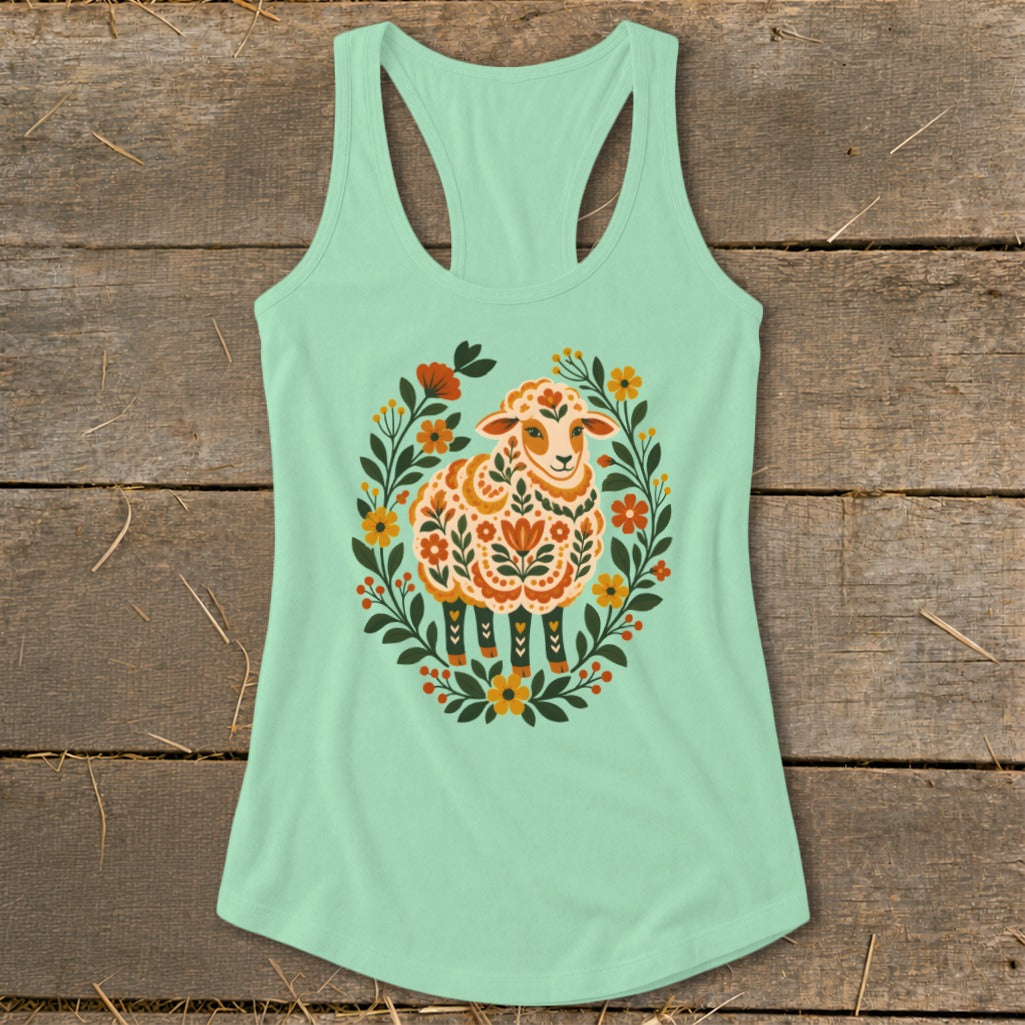 Light green tank top with a folk-art inspired sheep surrounded by floral wreath.