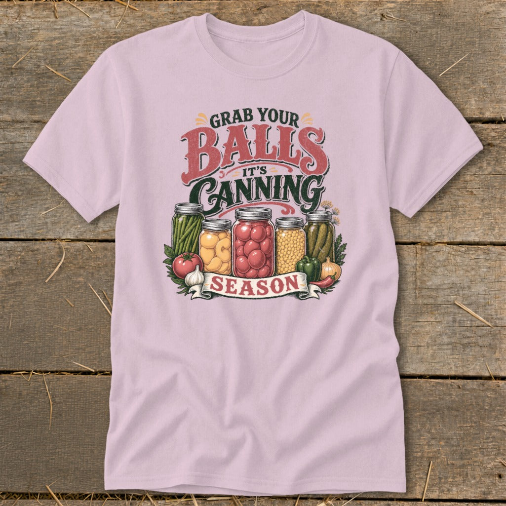 Pink t-shirt with "Grab Your Balls It's Canning Season" text and jars of produce.