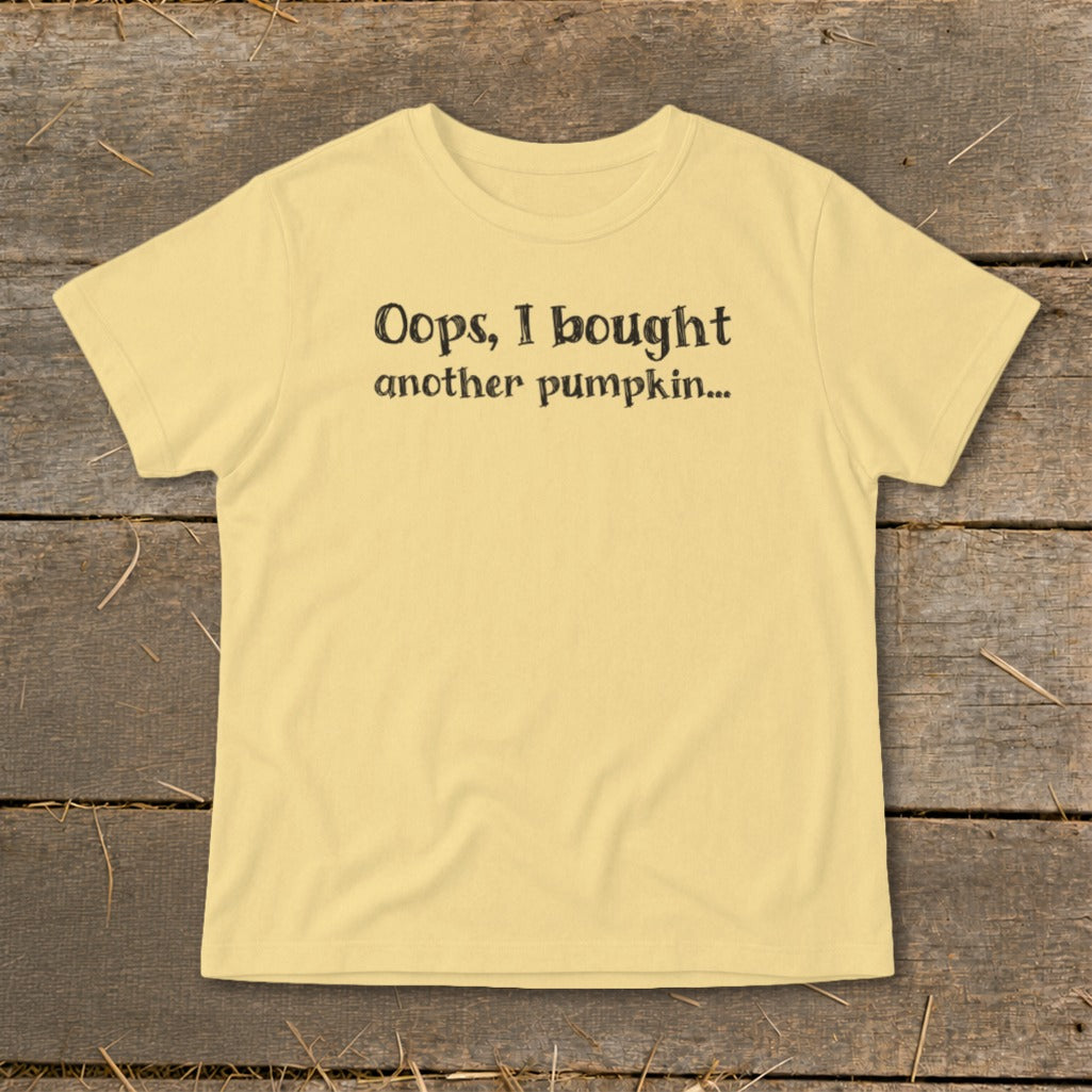 Yellow t-shirt with black text reading "Oops, I bought another pumpkin..."
