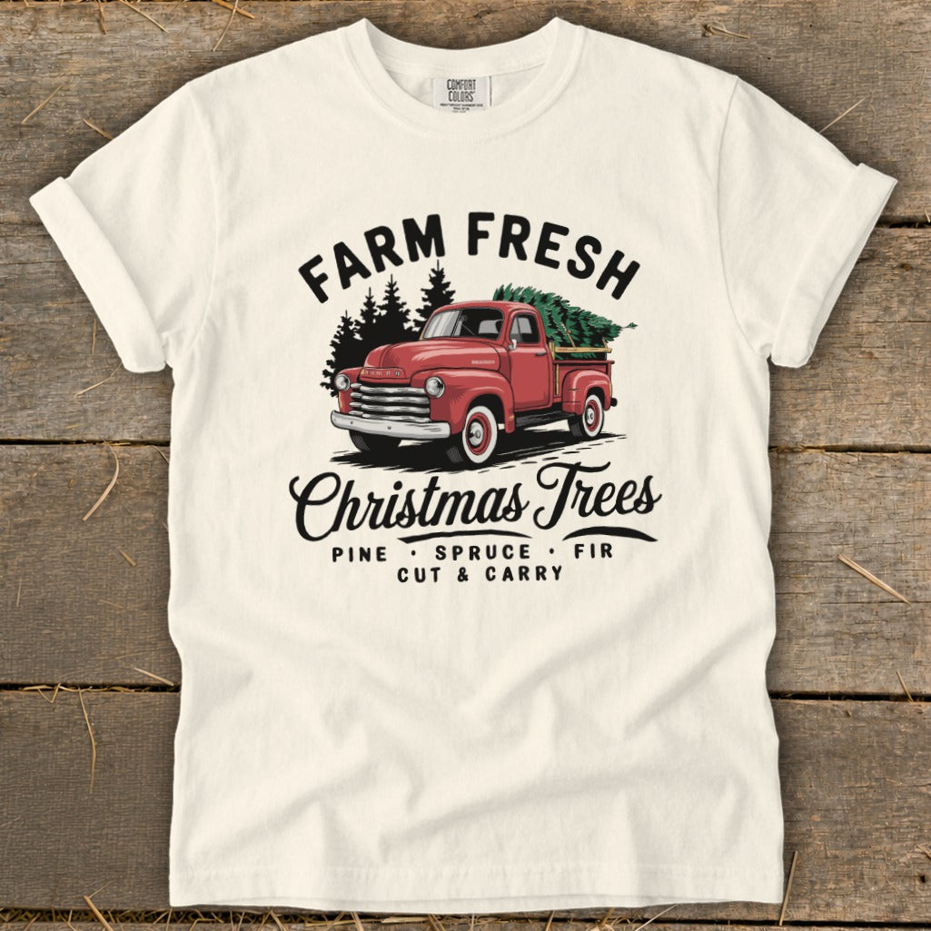 White t-shirt with vintage red truck carrying Christmas trees and text.