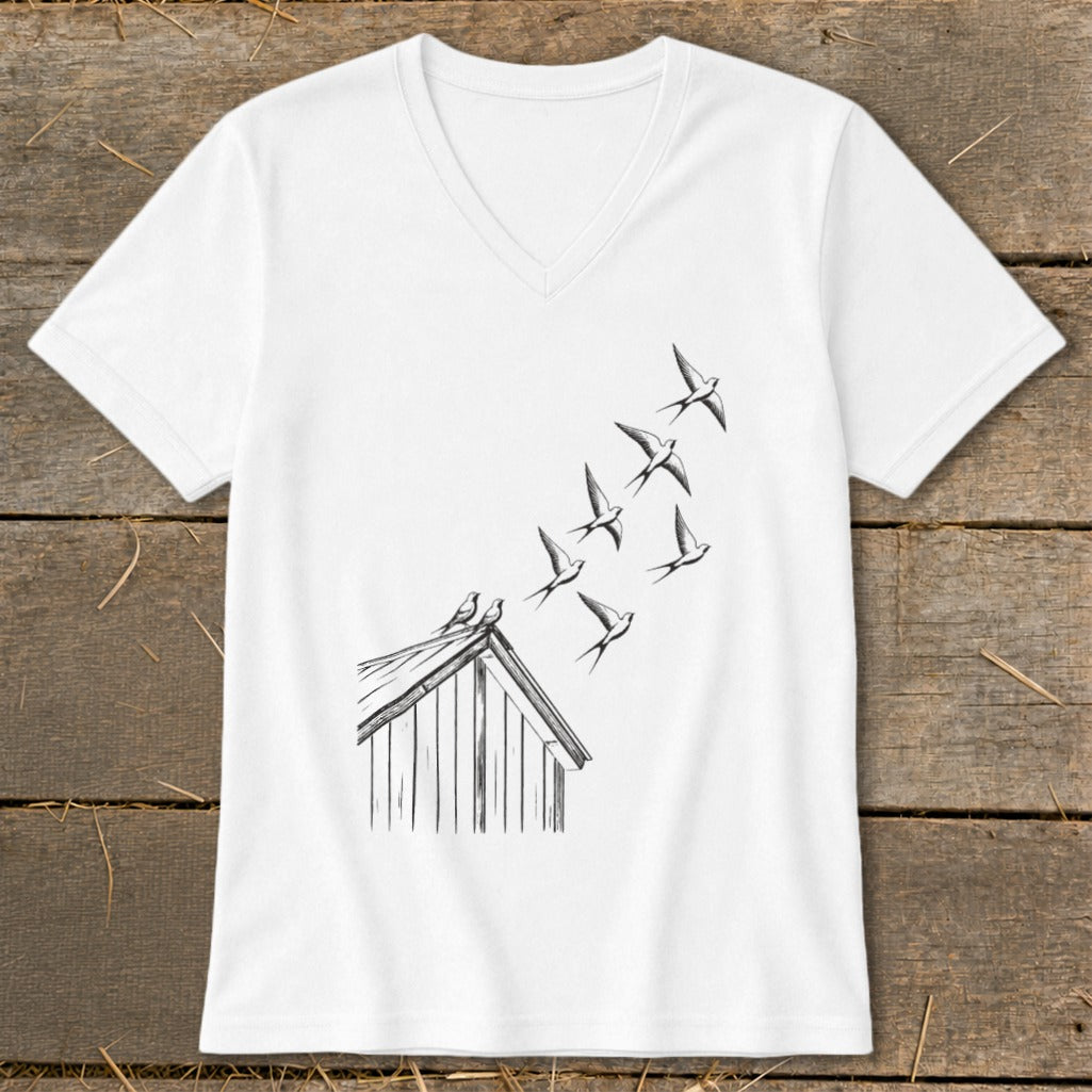 A white V-neck t-shirt featuring a black line art graphic of a flock of birds taking flight from a rooftop.