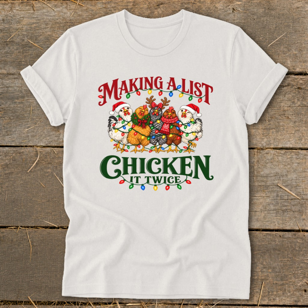 White t-shirt with "Making a list, chicken it twice" text and festive chickens.
