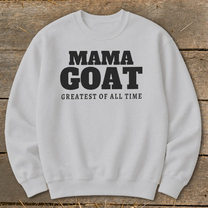 White sweatshirt with "MAMA GOAT GREATEST OF ALL TIME" text in black.