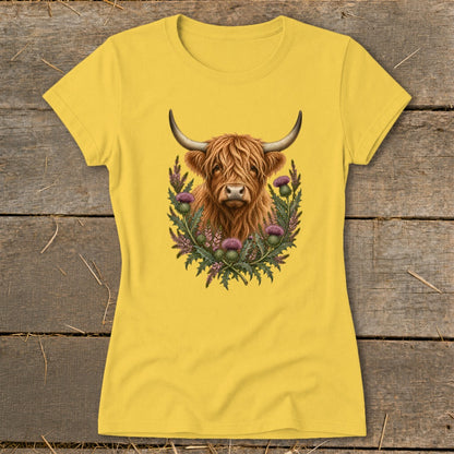 Yellow t-shirt with Highland cow and thistles graphic design.