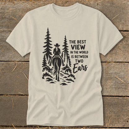 A light-colored t-shirt with a black graphic of a horseback rider in the woods and text.