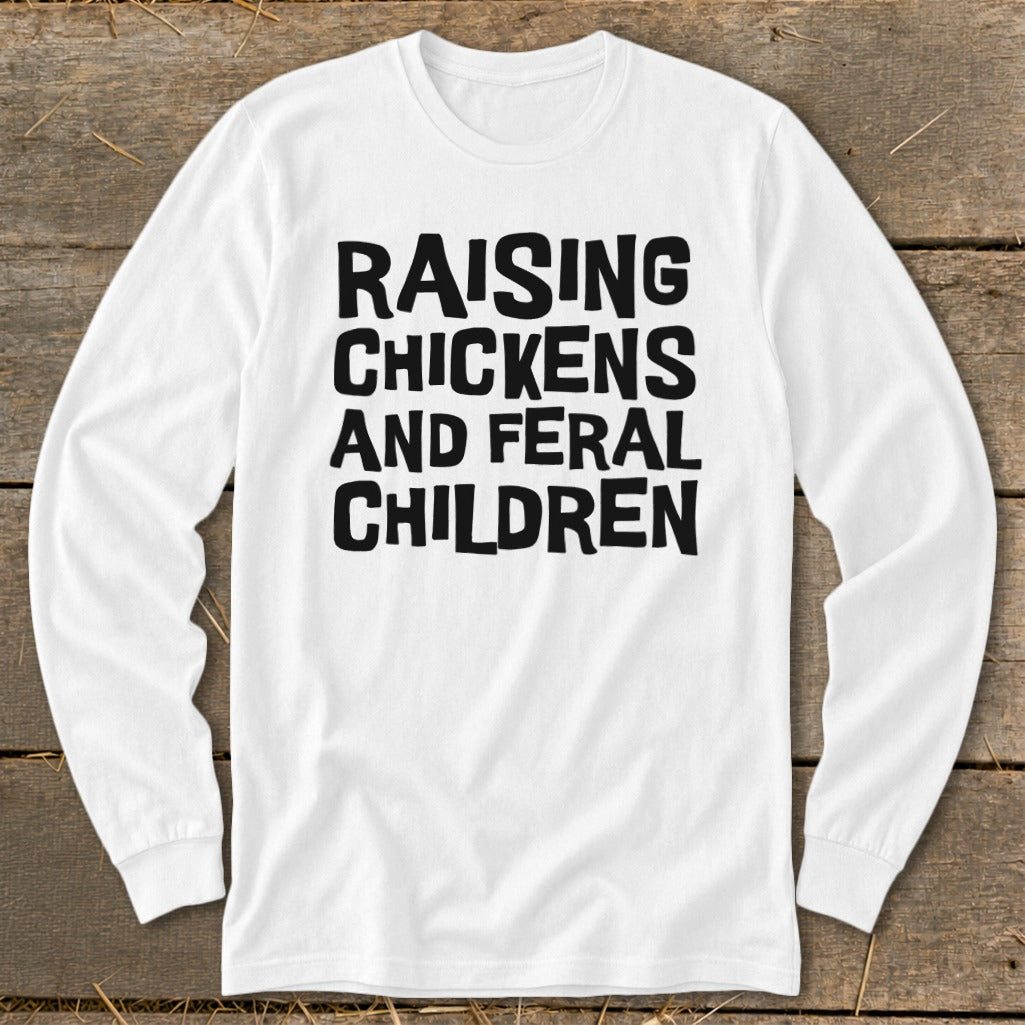 White long-sleeve shirt with black text reading "RAISING CHICKENS AND FERAL CHILDREN".