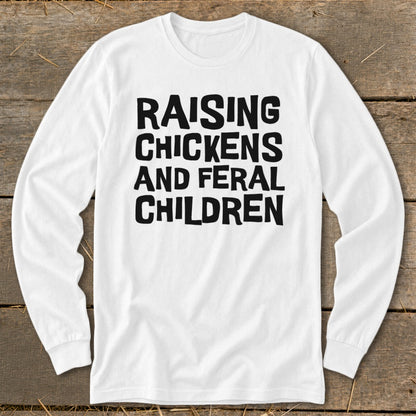White long-sleeve shirt with black text reading "RAISING CHICKENS AND FERAL CHILDREN".