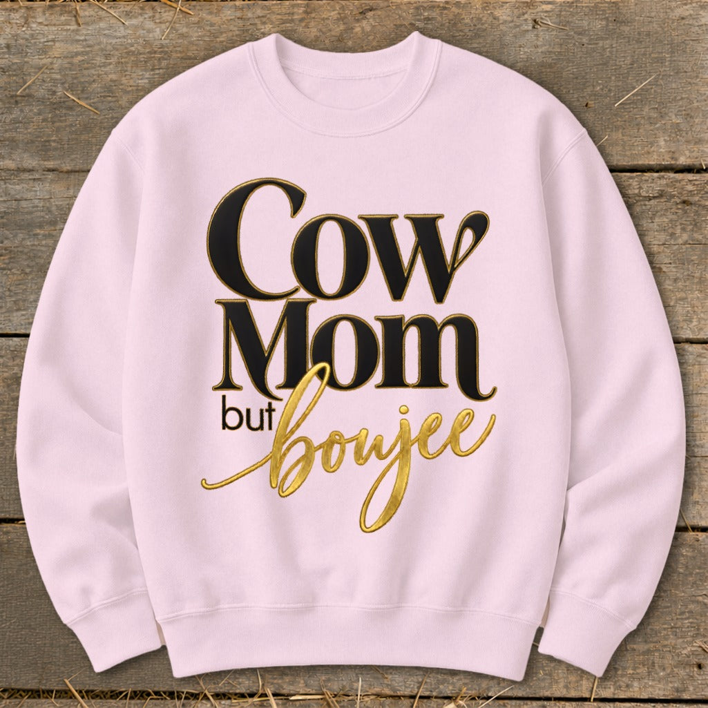 Pink crewneck sweatshirt with black and gold text that reads "Cow Mom but boujee."