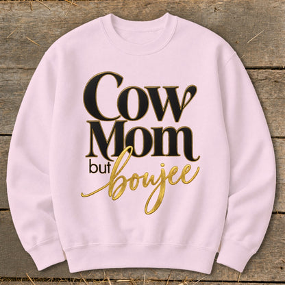 Pink crewneck sweatshirt with black and gold text that reads "Cow Mom but boujee."