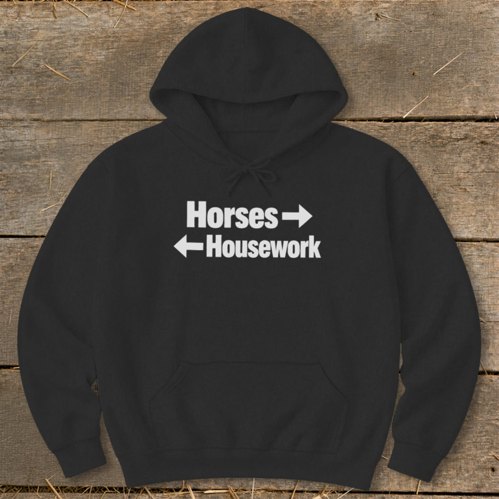 Black hooded sweatshirt featuring white text that reads Horses with a right arrow and Housework with a left arrow.
