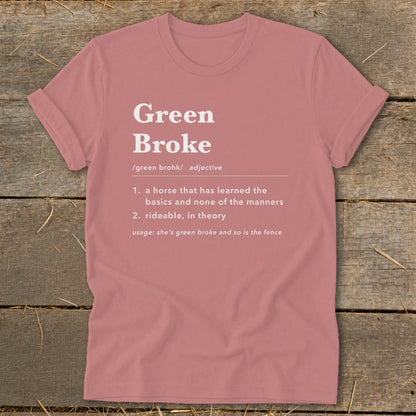Dusty pink t-shirt with white dictionary-style text defining Green Broke laid on a wooden background.