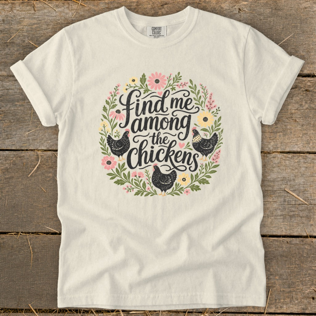 Cream t-shirt with floral wreath and text "Find me among the chickens."