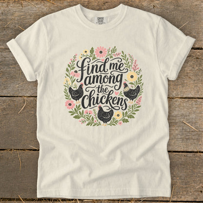 Cream t-shirt with floral wreath and text "Find me among the chickens."