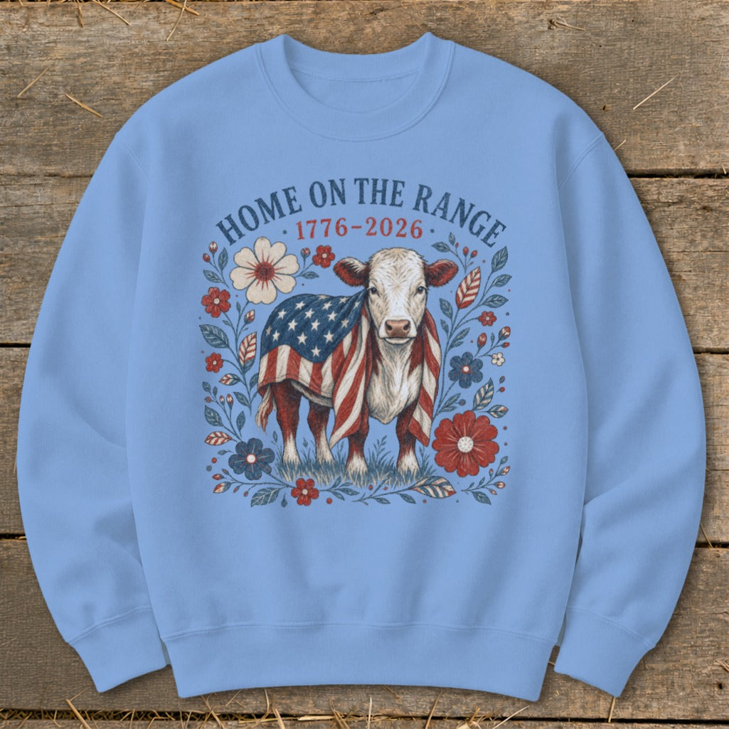 Cow wearing American flag blanket surrounded by flowers and text "HOME ON THE RANGE 1776-2026".