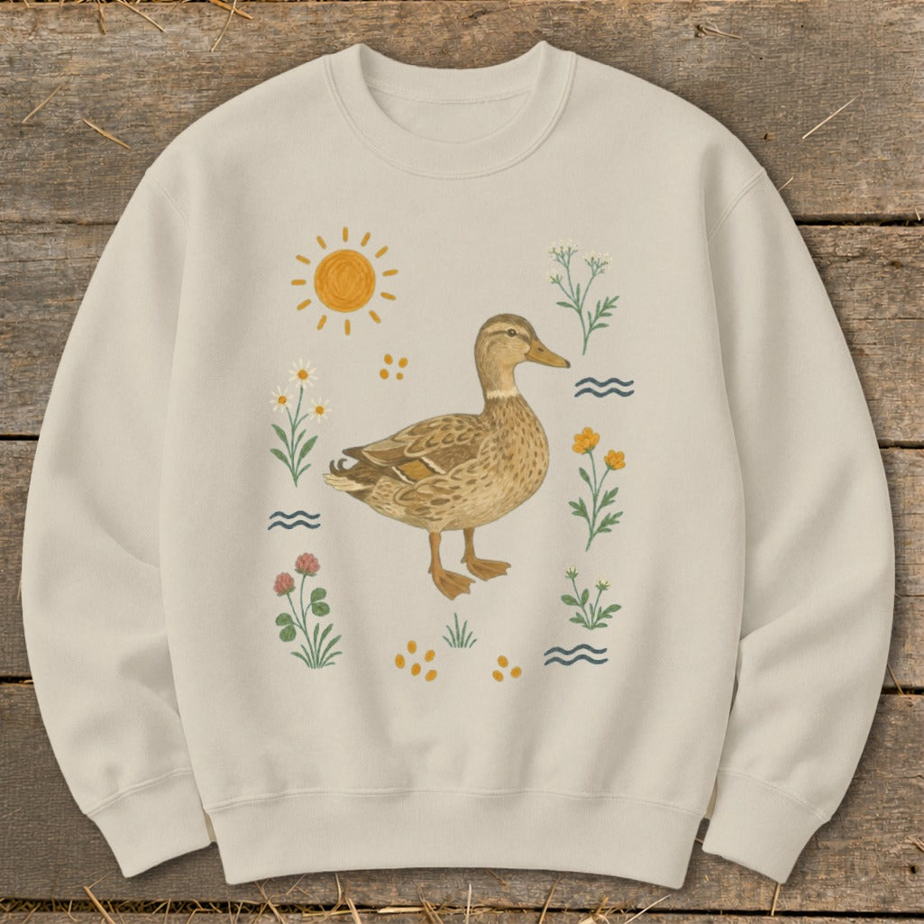 Crewneck sweatshirt with a duck illustration surrounded by flowers, sun, and waves.