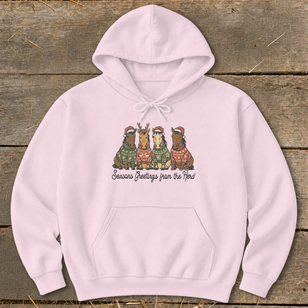 Pink hoodie with four horses wearing Santa hats and sweaters, text "Seasons Greetings from the Herd".