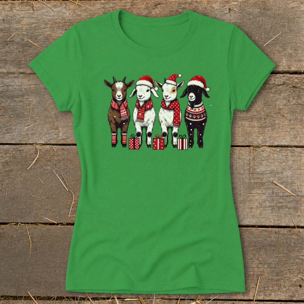 Four goats wearing Santa hats and scarves with Christmas gifts on a green shirt.
