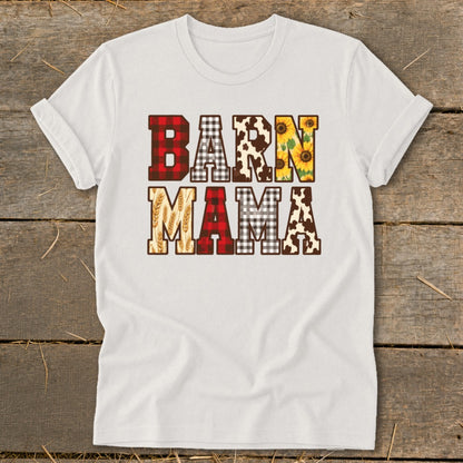A white t-shirt featuring the text BARN MAMA in a patchwork of plaid and animal print patterns.