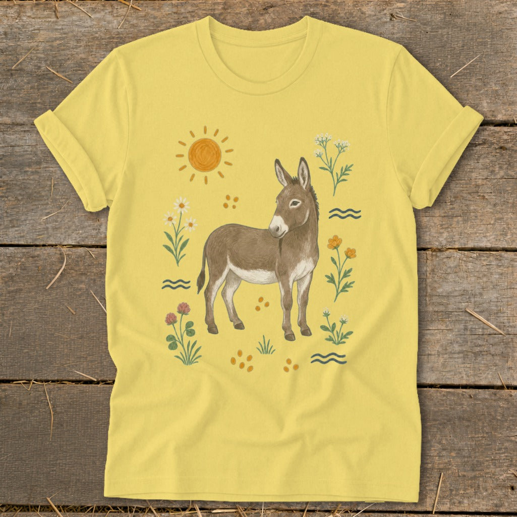 Yellow t-shirt with a watercolor illustration of a donkey surrounded by flowers and sun.