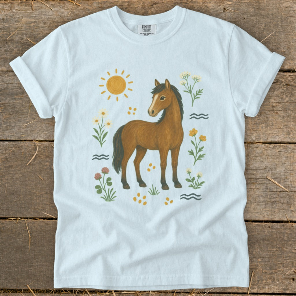 White t-shirt with a brown horse surrounded by flowers and a sun graphic.