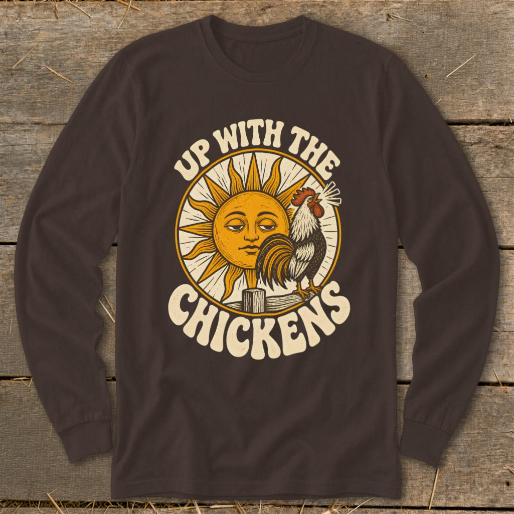 Dark brown long-sleeved shirt with a graphic of a crowing rooster, a smiling sun, and text reading "Up With The Chickens."