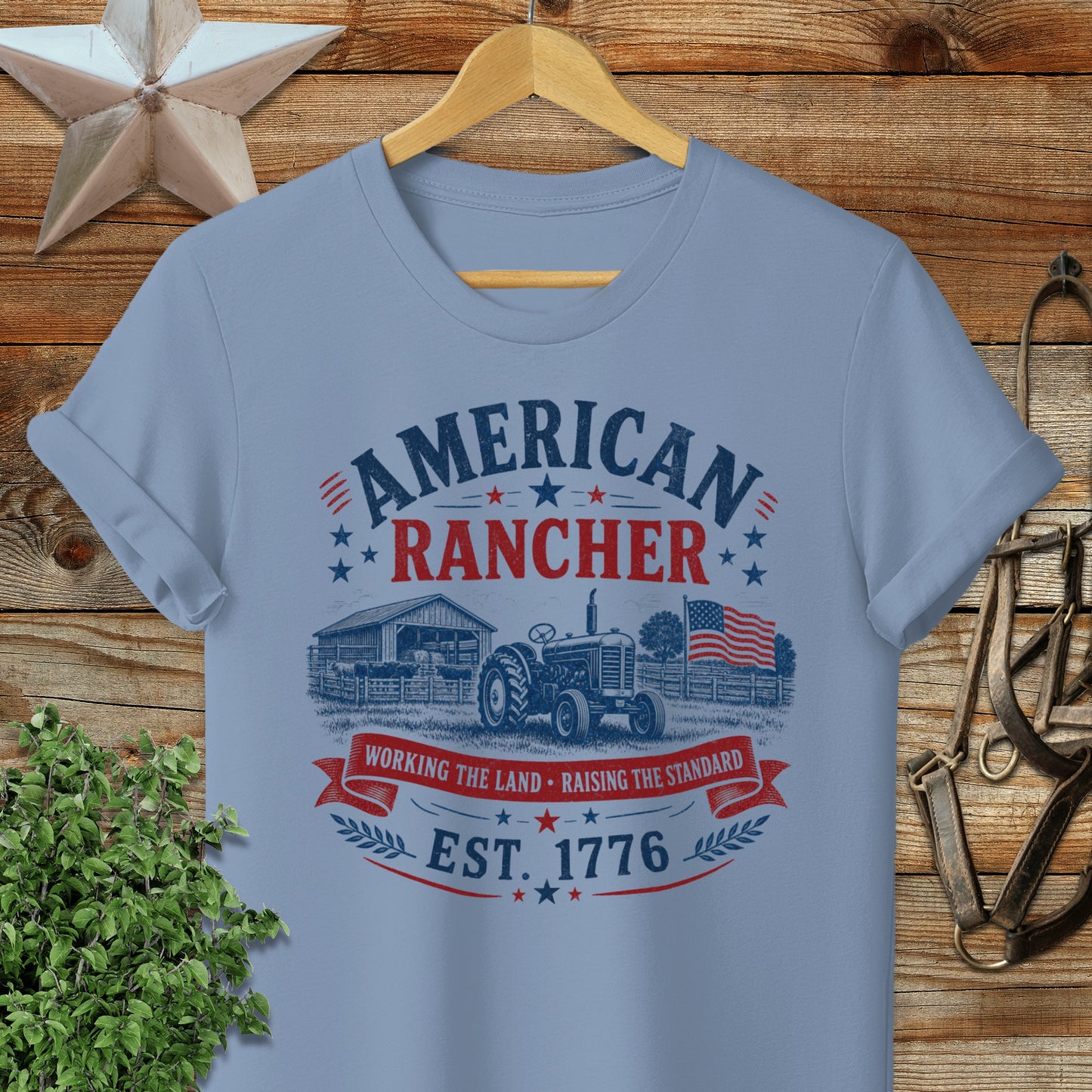 Light blue t-shirt with "American Rancher Est. 1776" text and farm imagery.