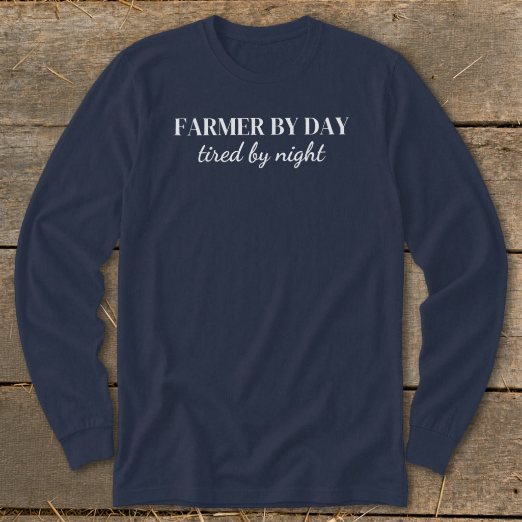 Navy long sleeve shirt with "FARMER BY DAY tired by night" in white text.