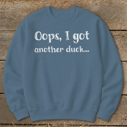 Blue sweatshirt with white text: "Oops, I got another duck..."