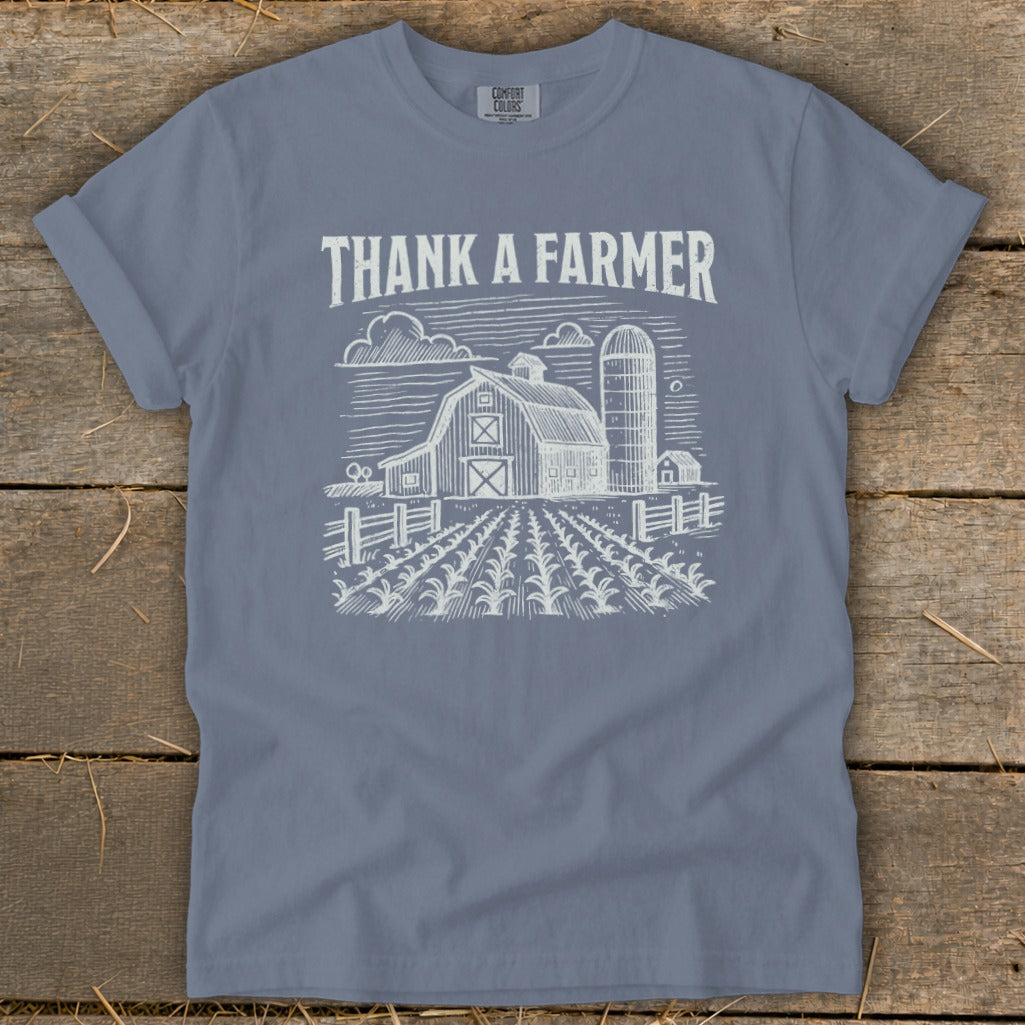 Blue t-shirt with "THANK A FARMER" text and a barn illustration.