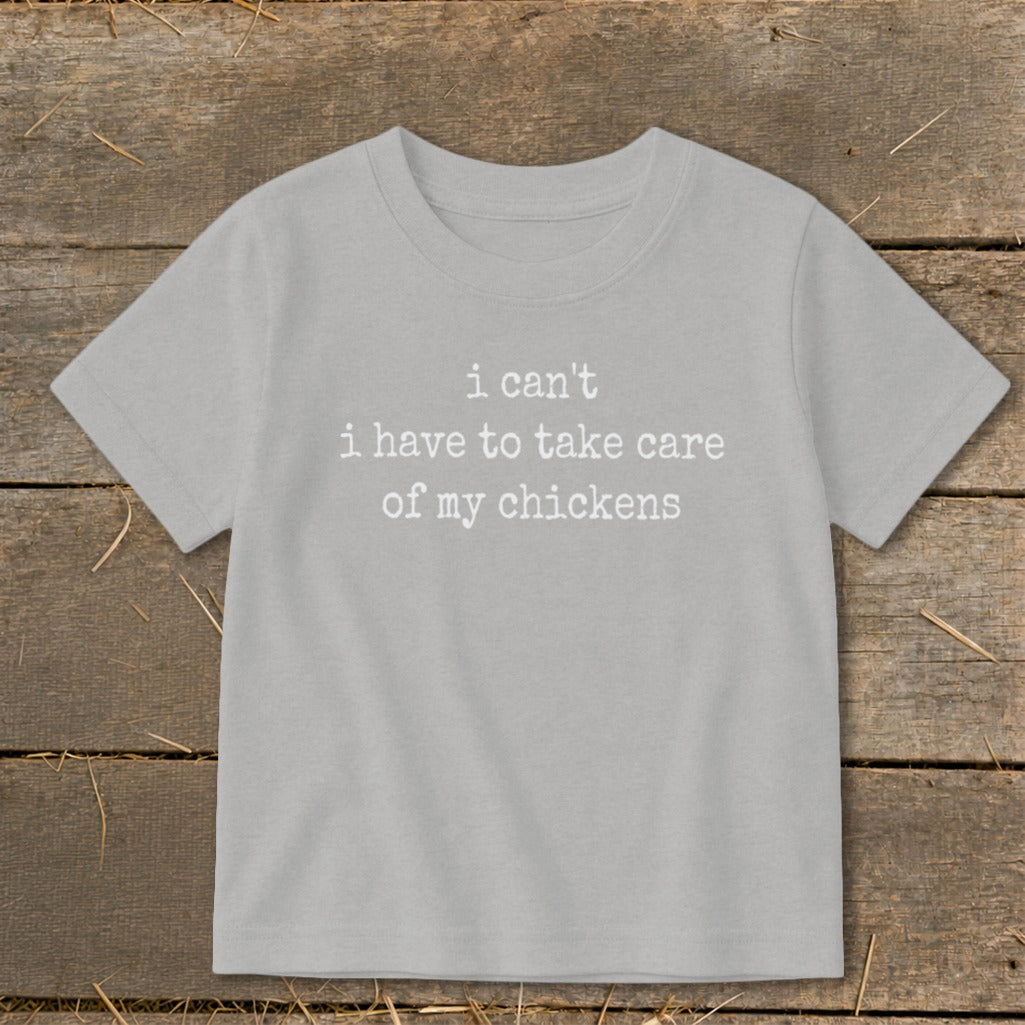 Light grey t-shirt with white text "i can't i have to take care of my chickens".