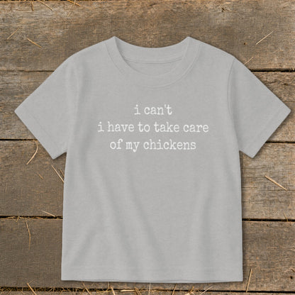 Light grey t-shirt with white text "i can't i have to take care of my chickens".