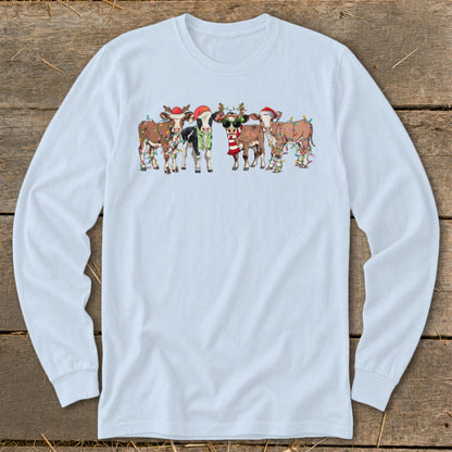 Five cows wearing Santa hats and Christmas lights, some with scarves.