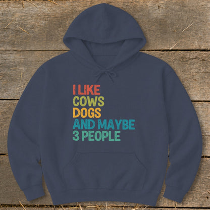 Navy hoodie with "I like cows dogs and maybe 3 people" text.