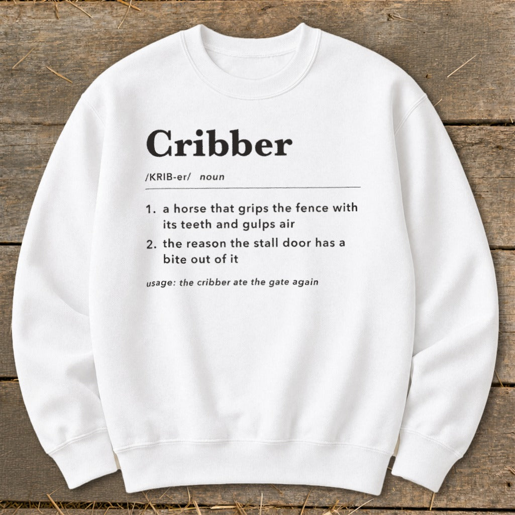 White crewneck sweatshirt printed with a humorous dictionary-style definition of the word cribber.