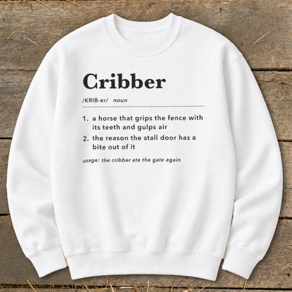 White crewneck sweatshirt printed with a humorous dictionary-style definition of the word cribber.