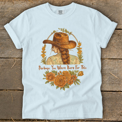 White t-shirt with a graphic of a woman in a cowboy hat and the text "Perhaps You Were Born For This."