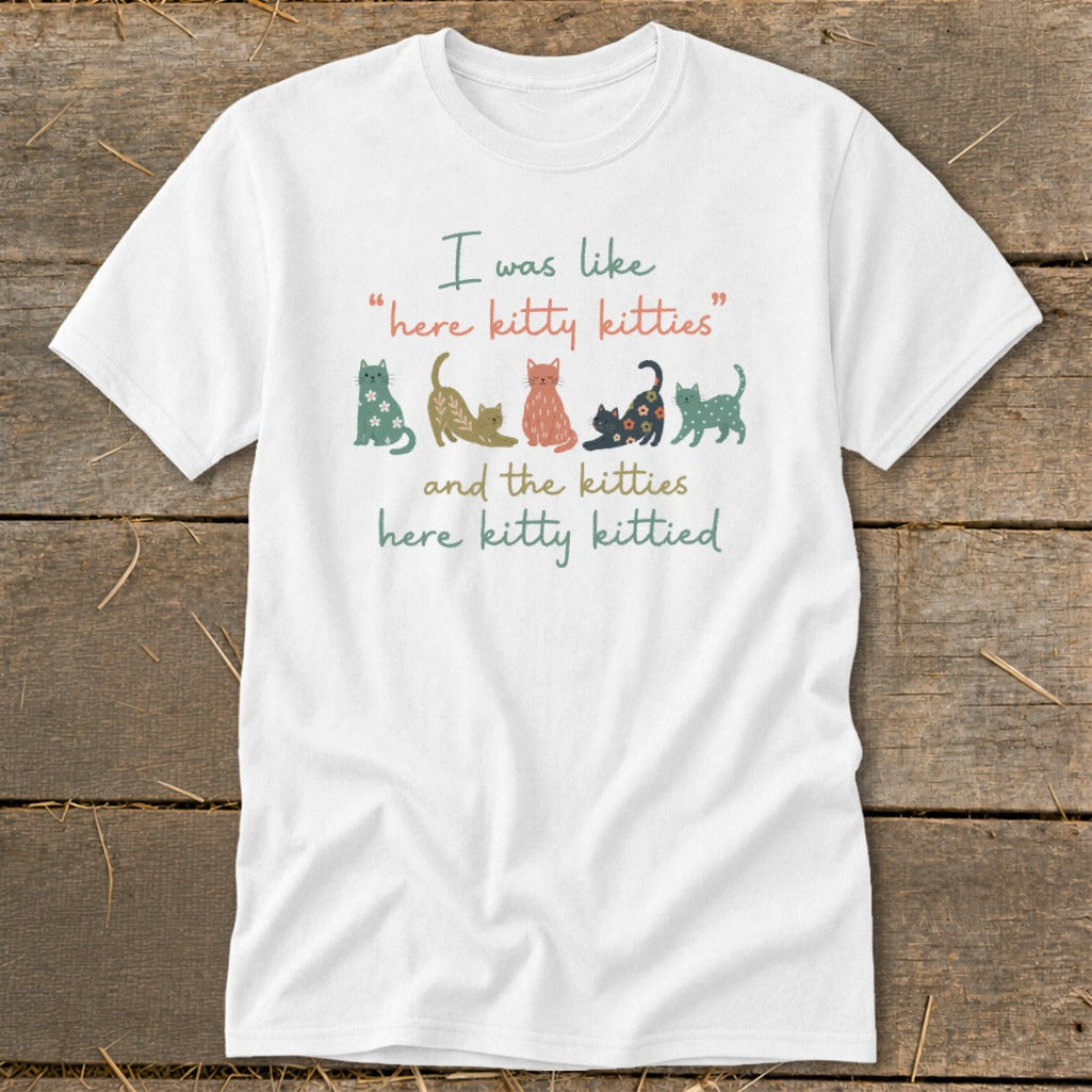 White t-shirt with text and colorful cat illustrations.
