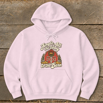 Pink hoodie with a graphic of a red barn and trees with the text "Jingle All the Way to the Barn".