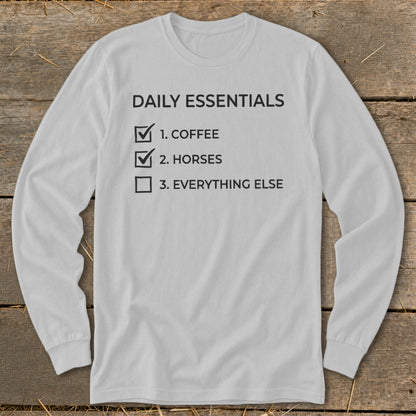 Long-sleeve shirt with "Daily Essentials" checklist: 1. Coffee, 2. Horses, 3. Everything else.