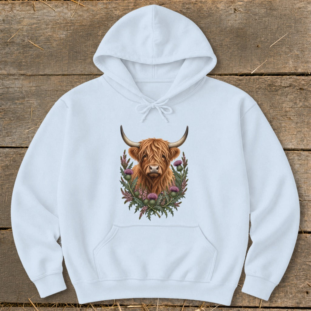 Light blue hoodie with a Highland cow and thistles graphic design.