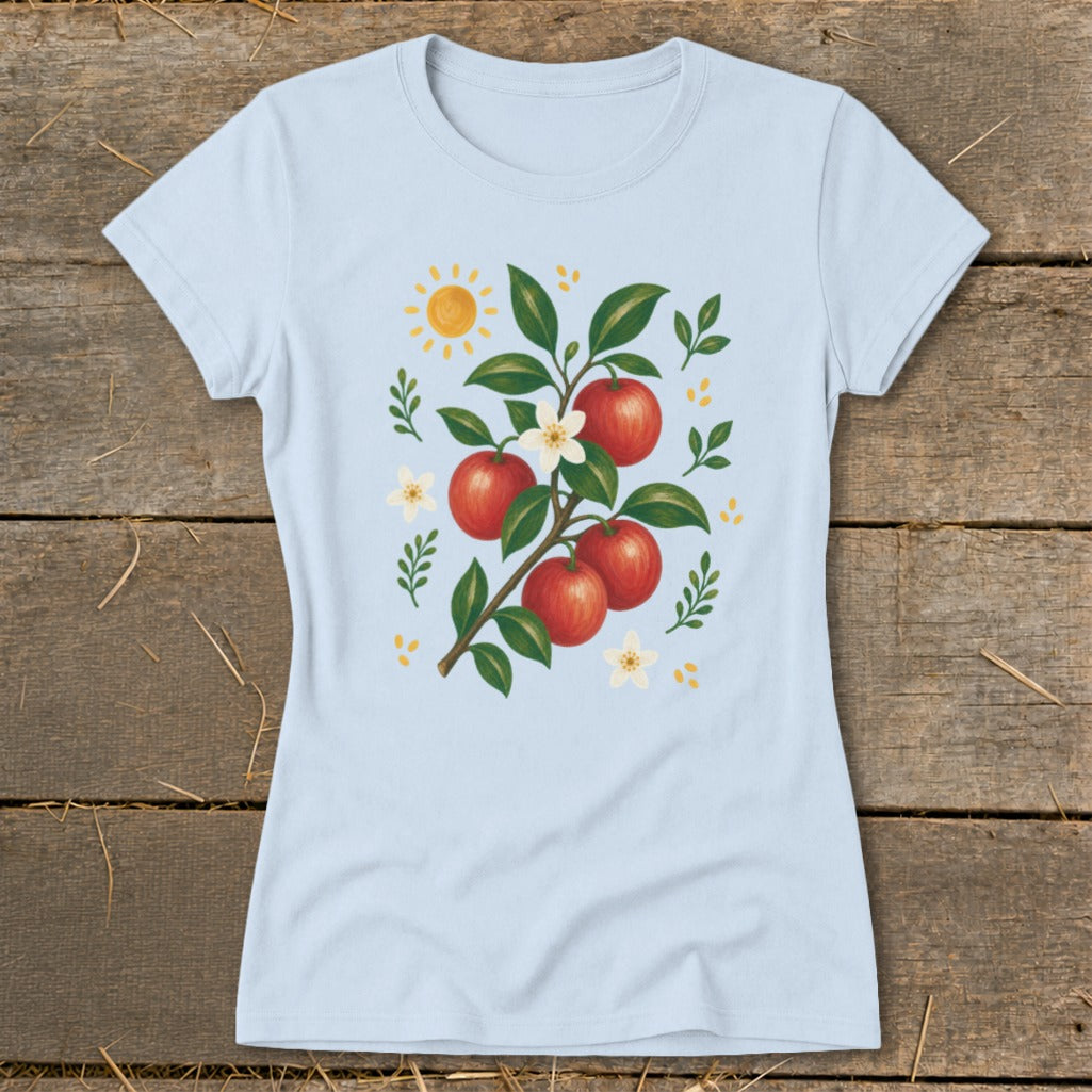 Light blue t-shirt with an illustration of a branch with red apples, white flowers, and a sun.