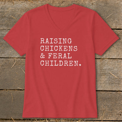 Red v-neck t-shirt with white text: "RAISING CHICKENS & FERAL CHILDREN."