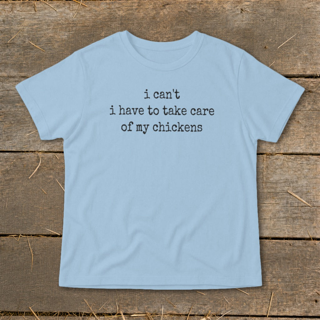 Light blue t-shirt with black text: "i can't i have to take care of my chickens".