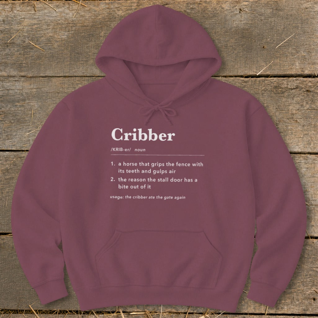 Maroon hoodie featuring white dictionary-style definition text for the word Cribber centered on the chest.