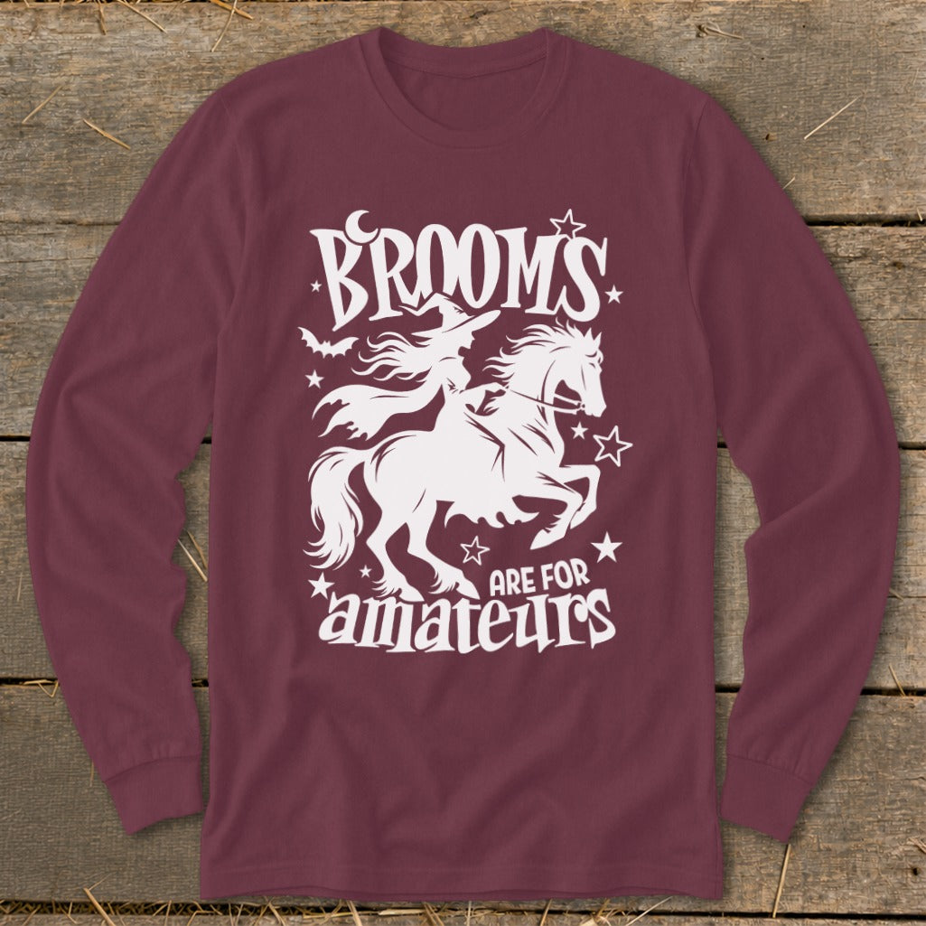 Maroon long-sleeve shirt with white graphic: witch riding horse, text "Brooms are for amateurs".